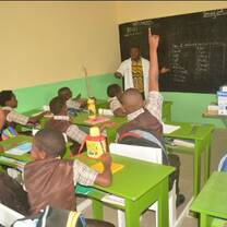 teacher teaching little children inside his classroom 