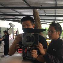 Two men looking at the video camer