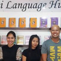 Five people standing with the books at the back