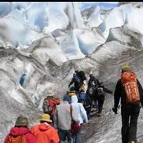 group of people hiking on an icy mountains 