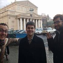 Three men standing outside the building