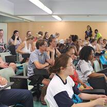 men and women listening to an orientation