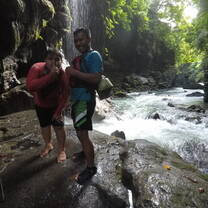 two guys swimming in the falls