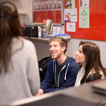 two girls and one guy talking