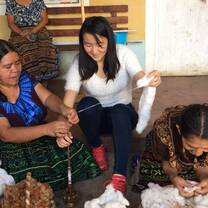 Participant learning to thread cotton