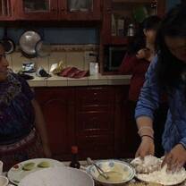 Participant cooking dinner with host family