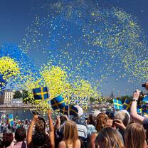 swedish festival with balloons in the air and people celebrating