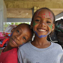 these two little girls has a paint on their face