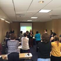 group of people standing and clapping