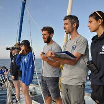 male and female students research on a boat
