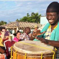 man playing drums in the middle of the stree