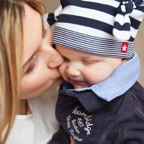 a woman kissing and cuddling a baby