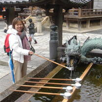 A woman posing with a dragon sculpture 