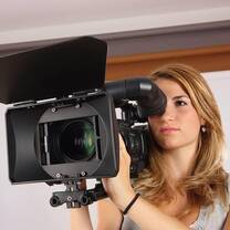 The girl is handling a video camera