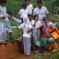 The big guy pointing something to the kids