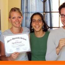 Three people holding their certificate