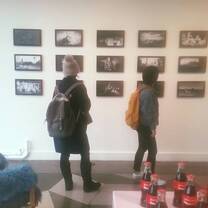 two girls looking at the images in the wall