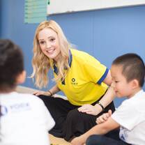 the lady talking to the kids
