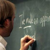 man writing in the blackboard