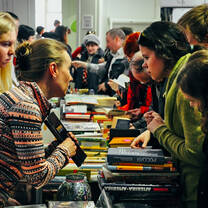 The girl is showing to other girl about the book