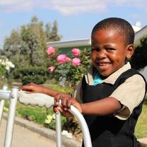 the young boy is  happy playing in the play area