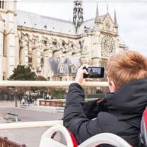 a man taking picture of Notre-Dame Cathedral - a huge and historical church