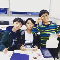 three boys holding their tablet