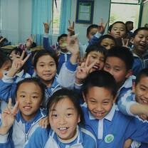 group of chinese kids in uniforms smiling