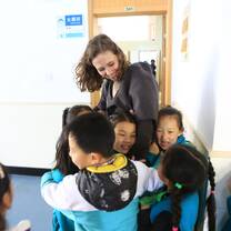 kids hugging woman 
