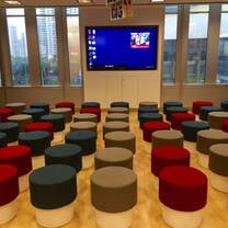 classroom with beanbag seats and a tv screen