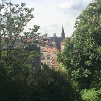 Parukářka, a park surrounded by trees with views of beautiful and historical buildings