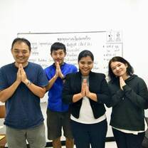 Four people standing with their hands "Looks like they are praying"