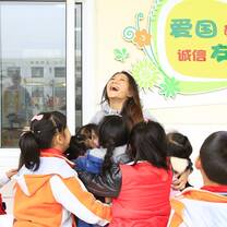 kids hugging and laughing in classroom 