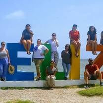 people around a Belize Sign