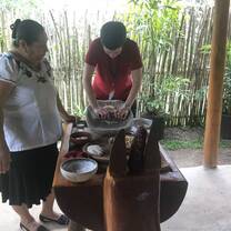 Participant learning how to use the grinding stone.