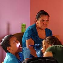 woman checking child's mouth