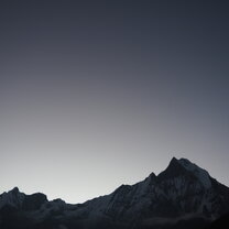 A silhouette of some of the highest mountains in the world Sunrise at Annapurna base camp in Nepal