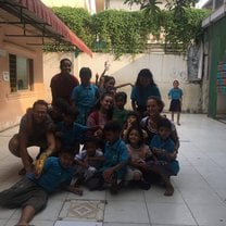 in the court yard of the school with other volunteers