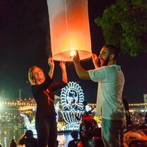 woman and man holding paper lantern in Thailand
