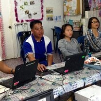 four people using laptop