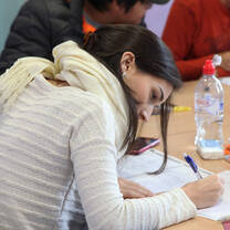 woman in white sweater studying