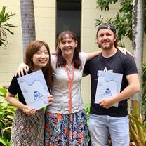 a picture of two ladies and man with their certificate