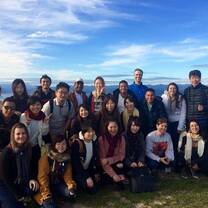 friends are amiling on the top of the mountain