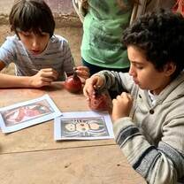 Students learning about "huacos" or ceramic art of Peru
