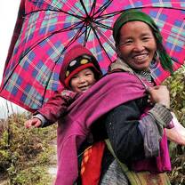 Vietnamese Indigenous mom carrying her baby on the back