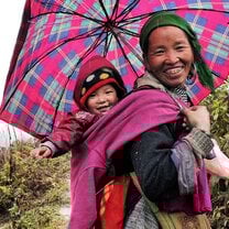 Vietnamese Indigenous mom carrying her baby on the back
