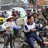 Passersby and motorcyclist Hanoi Vietnam