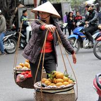 Vietnamese walking with fruits