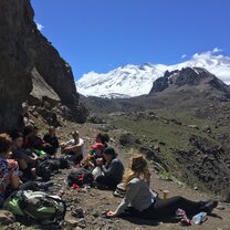 Hikers eating lunch overlooking mountains