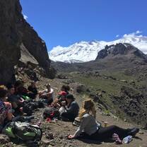 Hikers eating lunch overlooking mountains